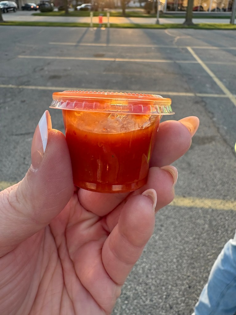 Small cup of red salsa.
